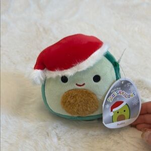 Squishmallow Austin the Avocado with Santa Hat, Christmas Edition.